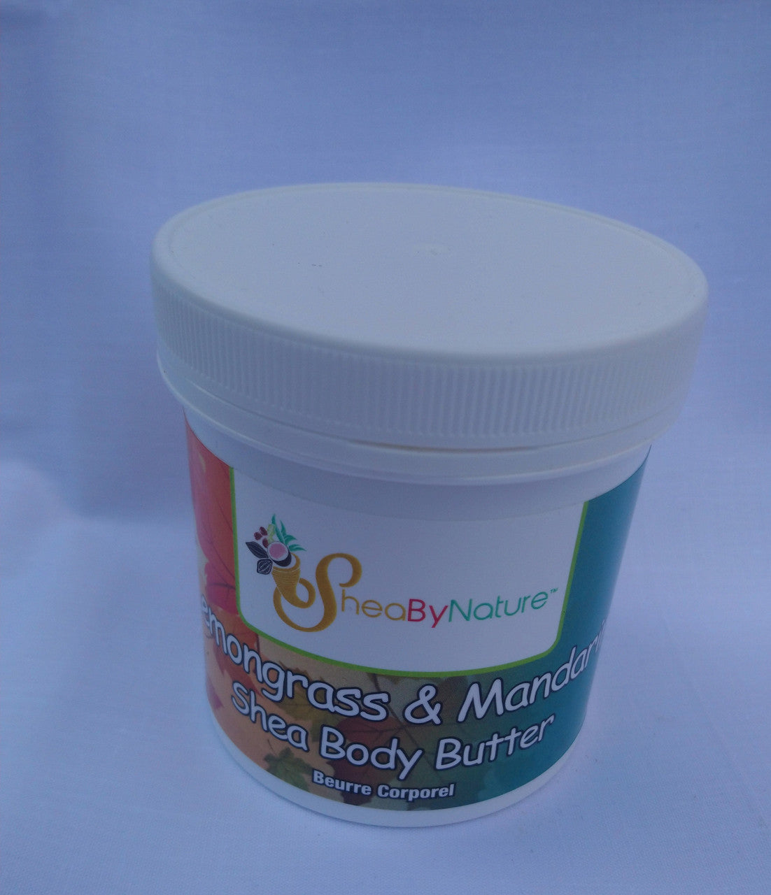 Shea body butter container with a white lid on a light blue background
