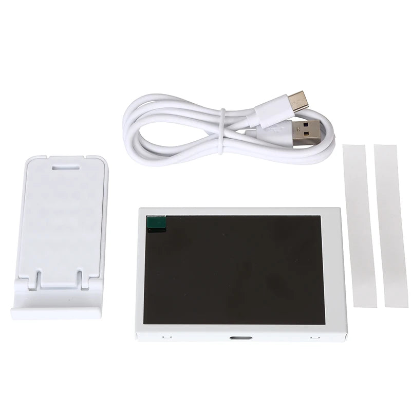 White electronic device with screen, charging cable, and additional components on a white background