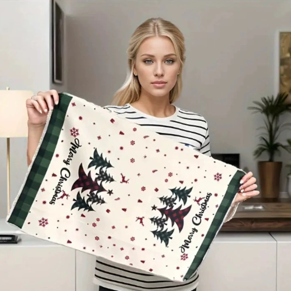Woman holding a Christmas-themed towel with decorative patterns