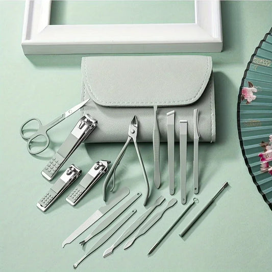 Set of metal manicure tools with a gray case on a light green background