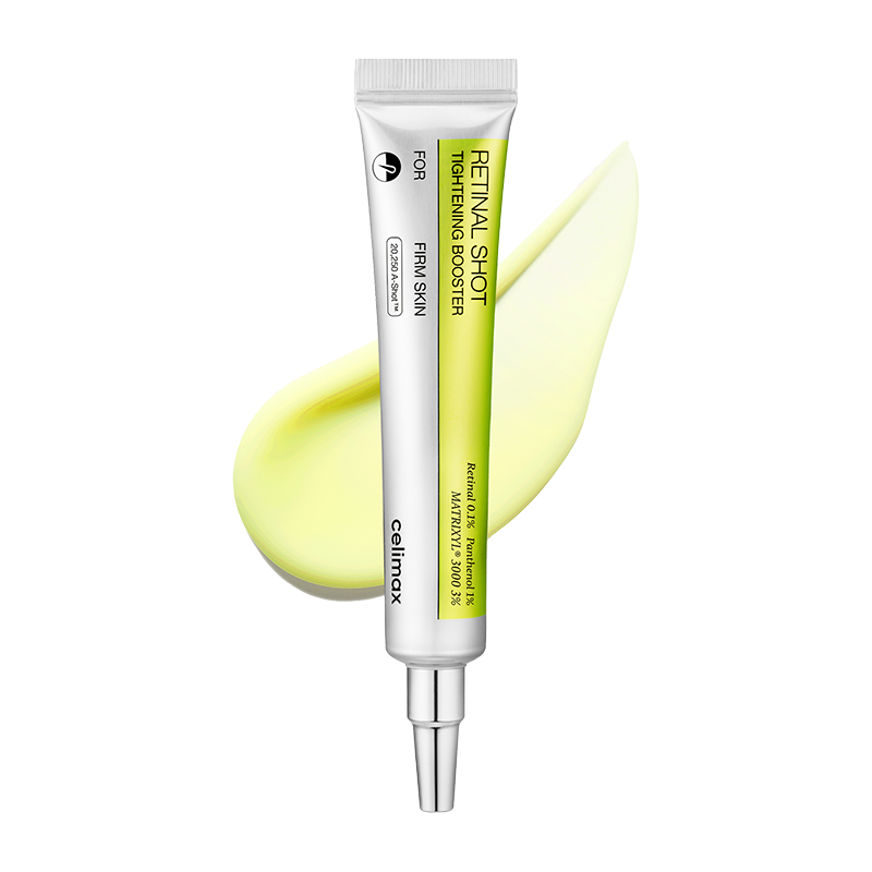 Skincare serum tube with a yellow smear on a white background
