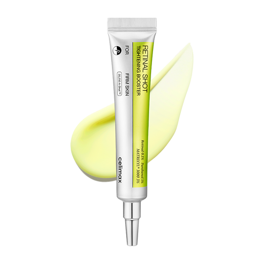 Skincare serum tube with a yellow smear on a white background