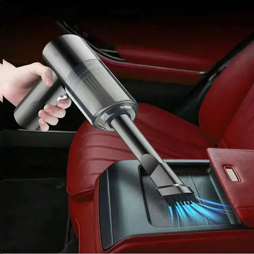 Hand using a handheld vacuum cleaner to clean a car seat.