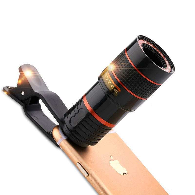 Phone with a clip-on telescope attachment on a white background