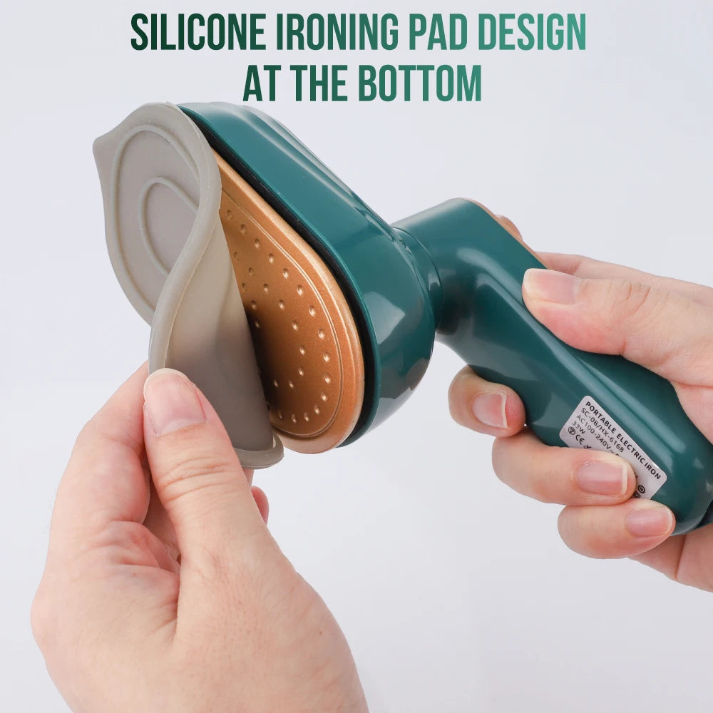 Person holding a green iron with a silicone ironing pad design on a white background