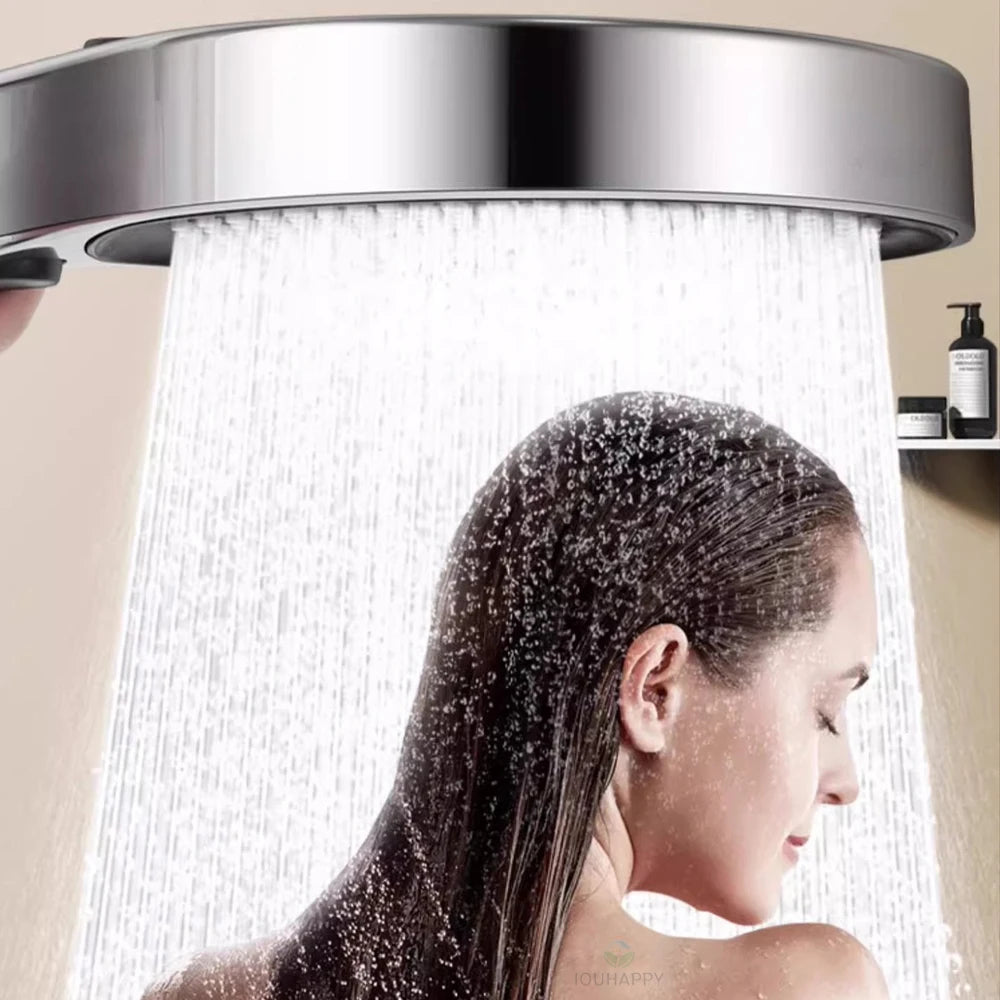 Person showering with a modern shower head in a bathroom setting.