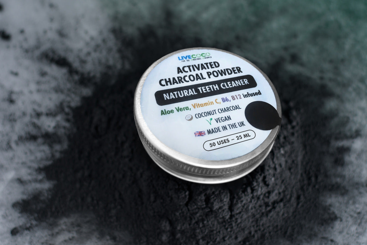 Container of activated charcoal powder on a textured black background