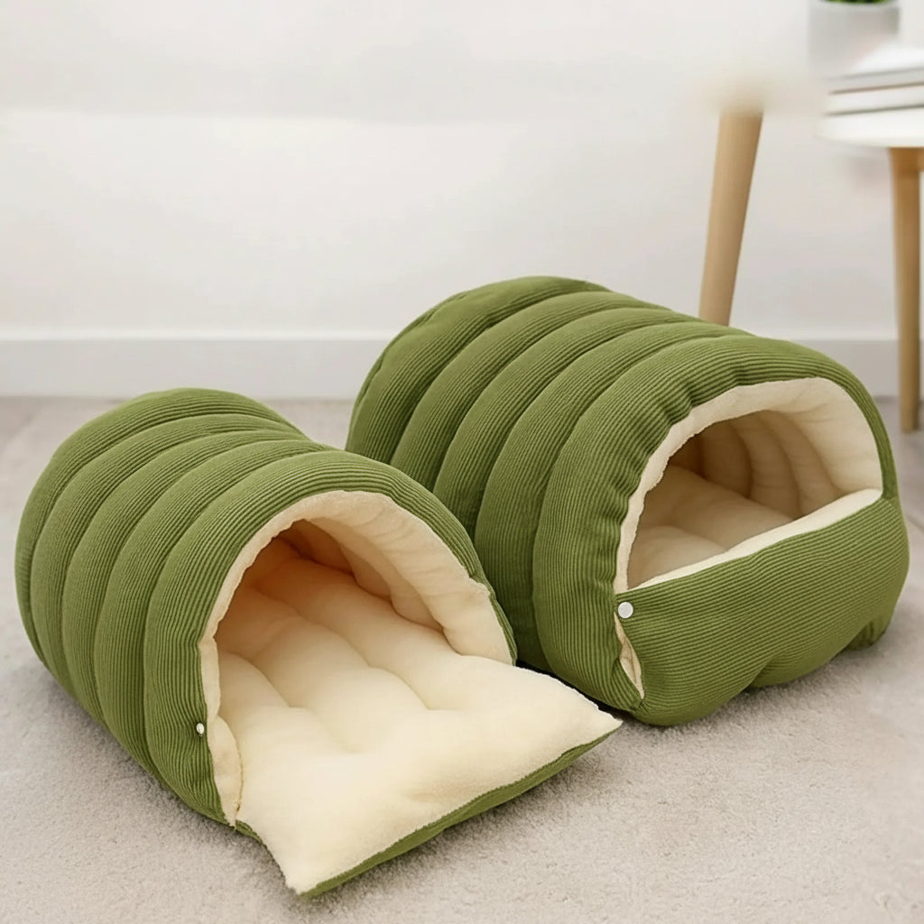 Green pet cave with side buckle fastening on a light carpeted floor.