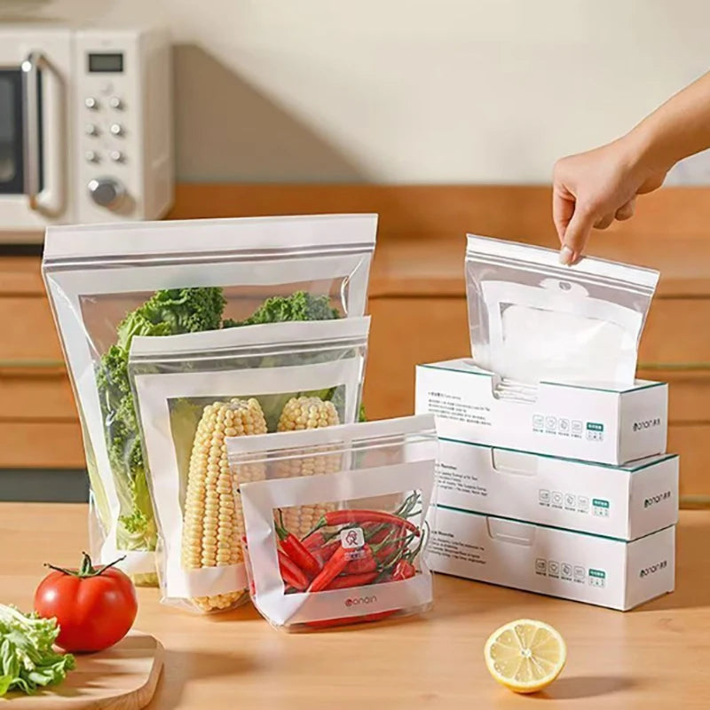 Person using vacuum seal bags with a box of the product on a kitchen counter.