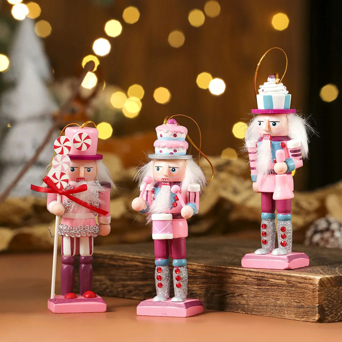 Three decorative nutcrackers in pink and white outfits with a festive background.