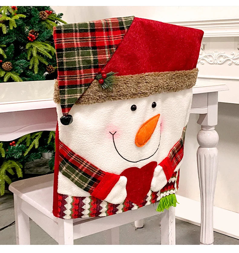 Christmas-themed snowman chair cover with plaid hat and scarf on a white chair.