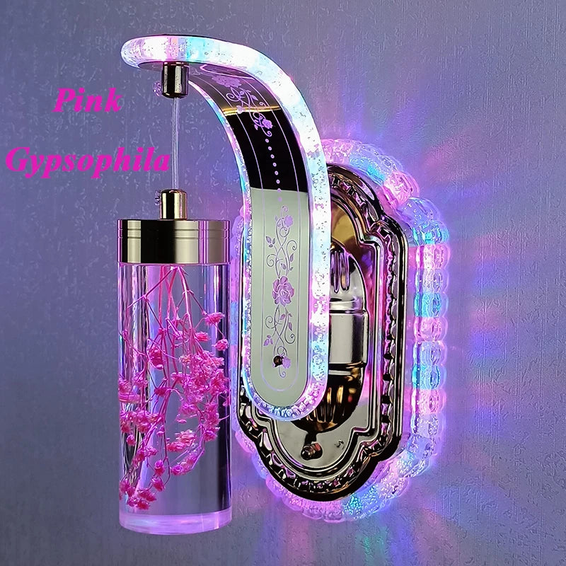 Decorative wall sconce with pink gypsophila and LED lighting on a gray background