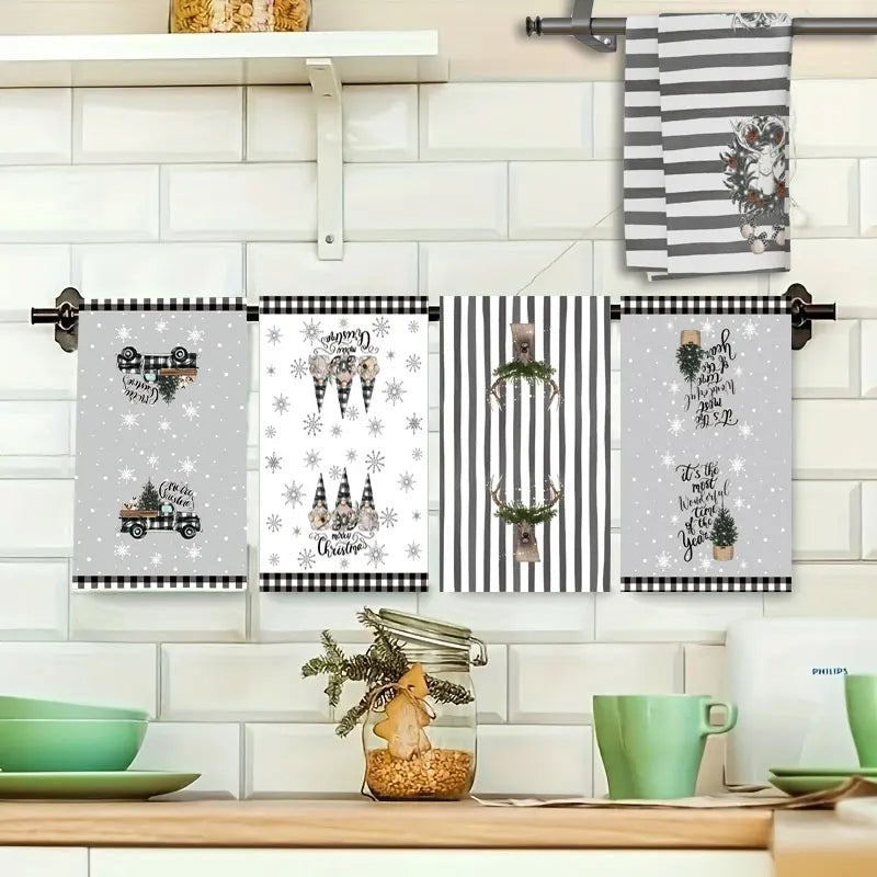 Set of decorative kitchen towels hanging on a rack with a festive design.