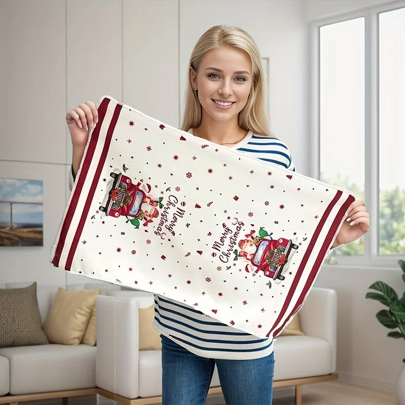 Woman holding a decorative towel with Christmas design in a living room.