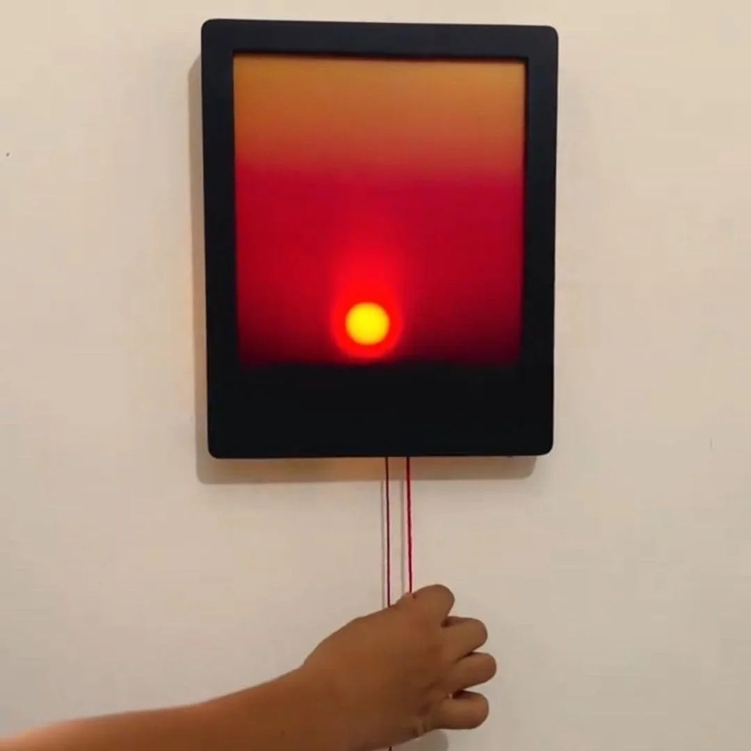 Thermographic camera screen displaying a red light with a hand reaching towards it.