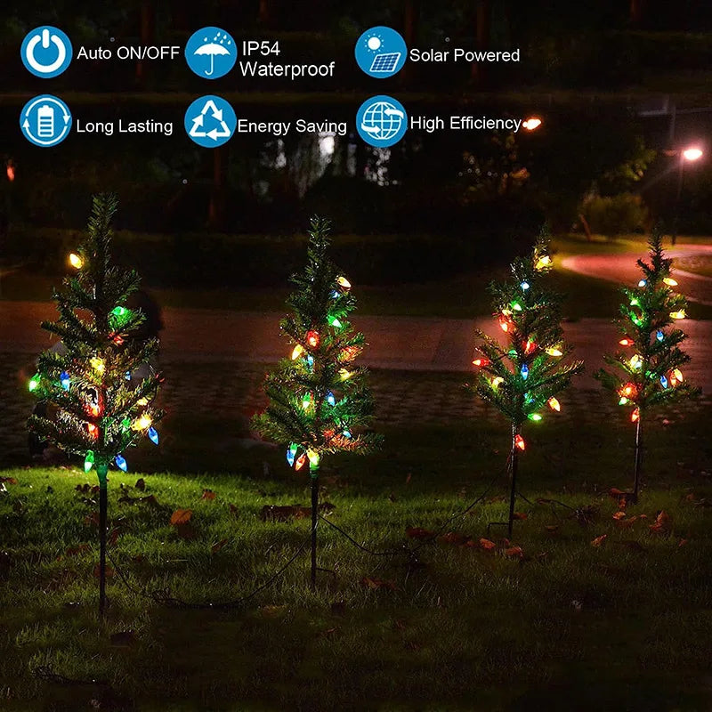 Decorative trees with colorful lights on grass at night, featuring solar-powered and energy-saving features.