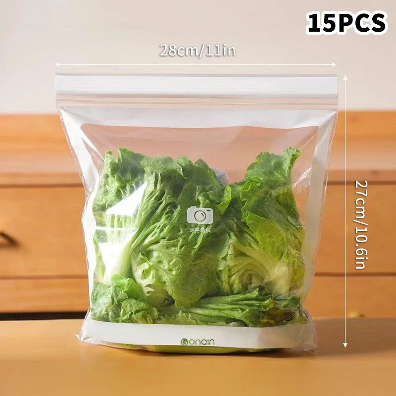 Clear vacuum-sealed bag with green leafy vegetables, dimensions indicated, on a wooden surface.