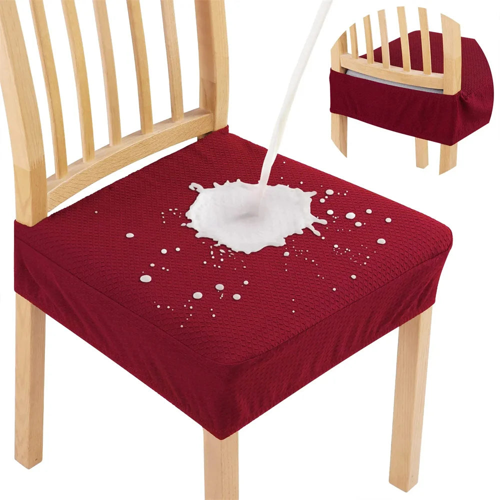 Red chair cushion with a white spill design on a wooden chair.
