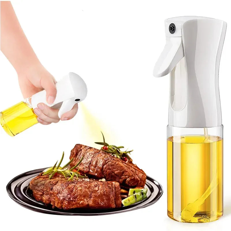 Olive oil sprayer being used to drizzle oil over cooked meat and vegetables on a plate.