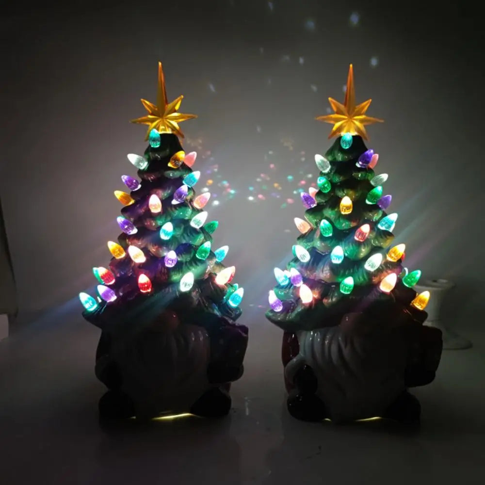 Two small Christmas trees with colorful lights and star toppers on a dark background.