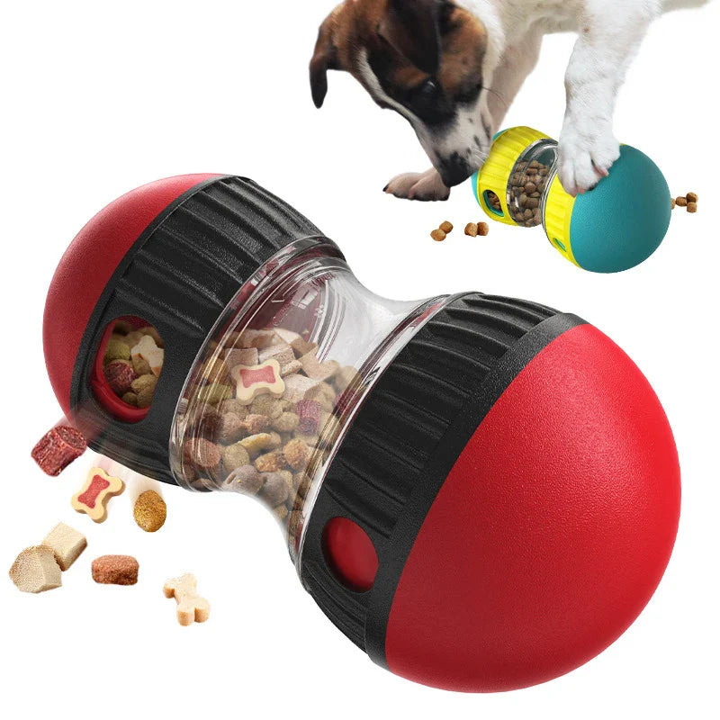 Red and black pet toy with food dispenser, dog interacting with it on a white background