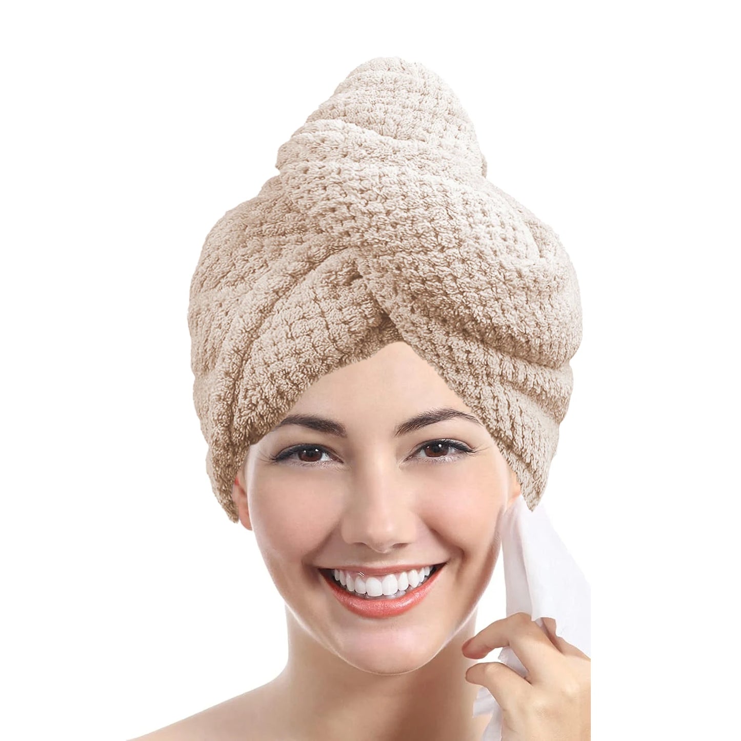 Woman wearing a beige towel turban on a white background