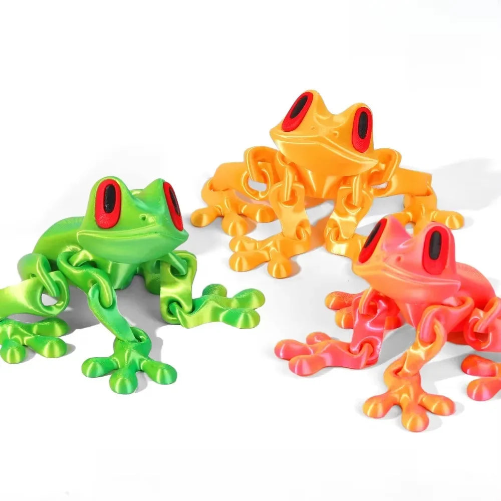 Three colorful plastic frogs on a white background