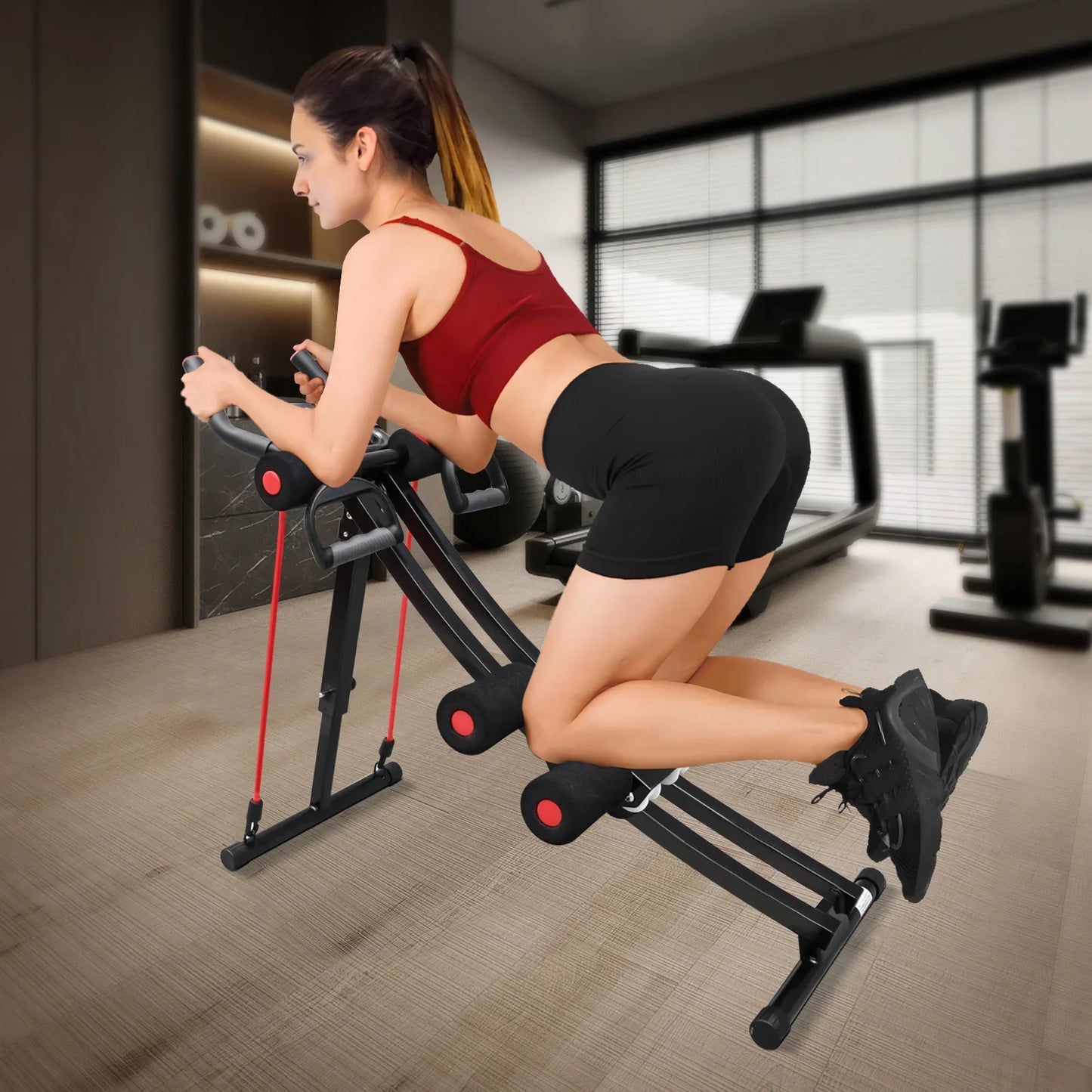 Woman exercising on a fitness machine in a modern gym.