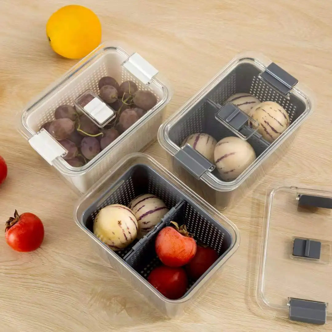 Three food storage containers with compartments on a wooden surface.