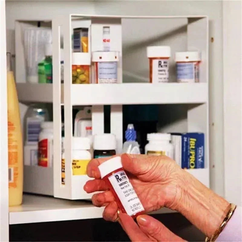 Hand holding a prescription bottle in front of a medicine cabinet with various medications.