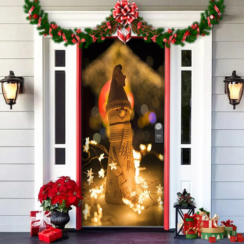 Decorative door with Christmas lights, garlands, and a silhouette of a woman holding a lantern.