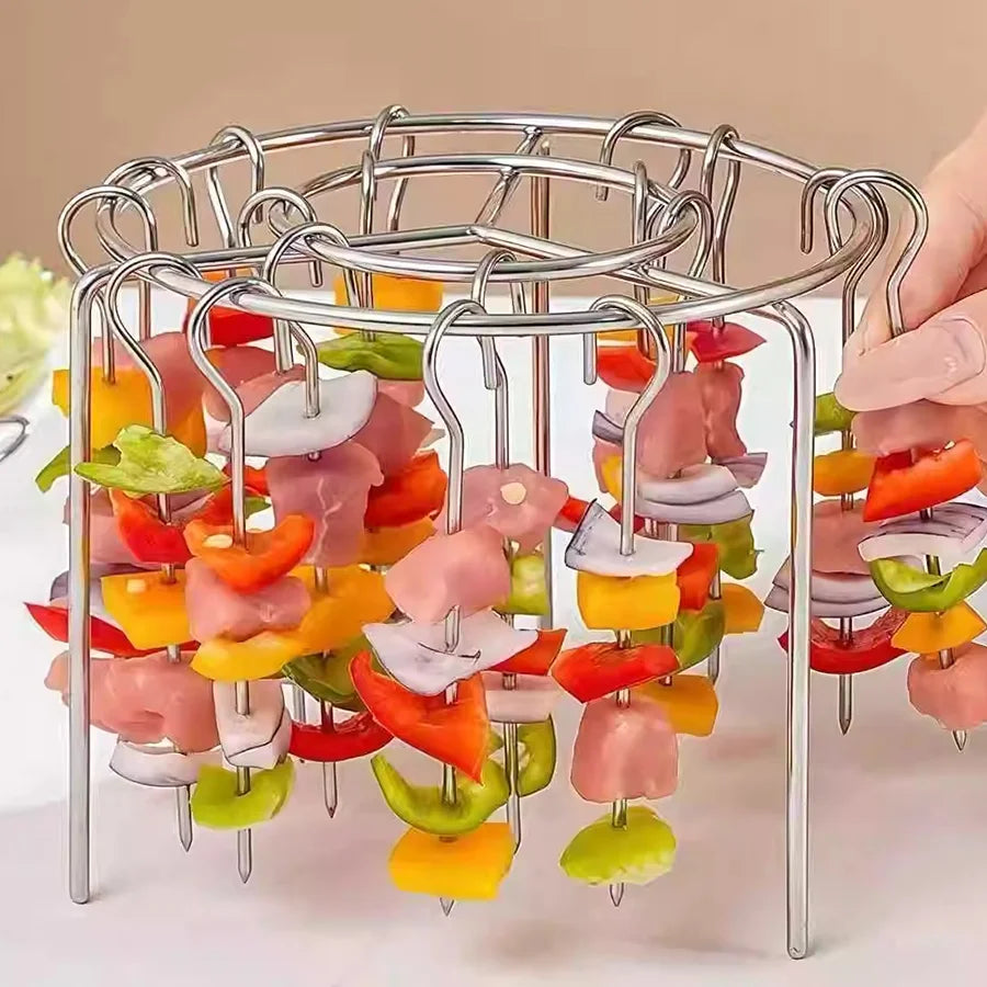 Metal skewer holder with colorful vegetables on a beige background