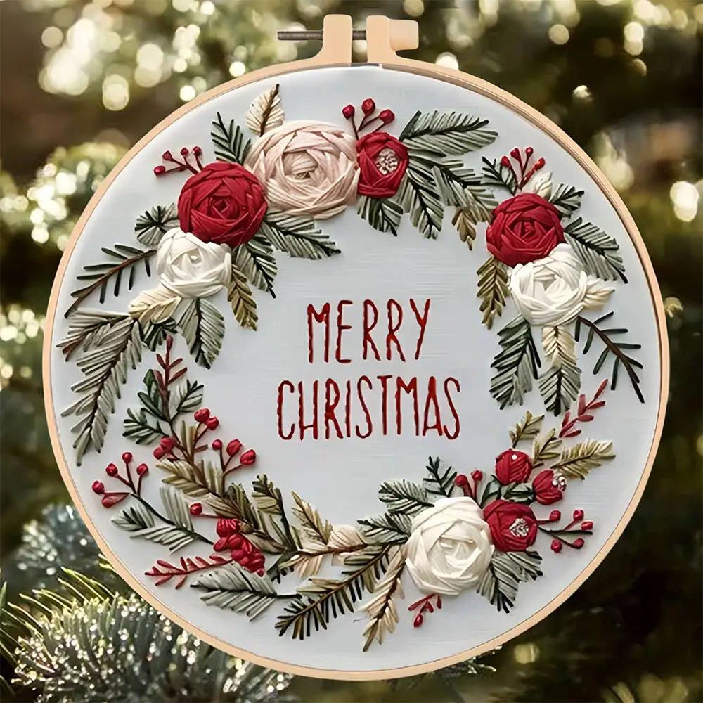 Embroidery hoop with floral design and 'Merry Christmas' text against a blurred Christmas tree background.