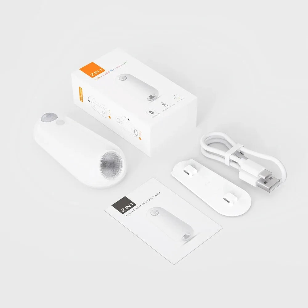Smart home device packaging with remote control, cable, and manual on a white background