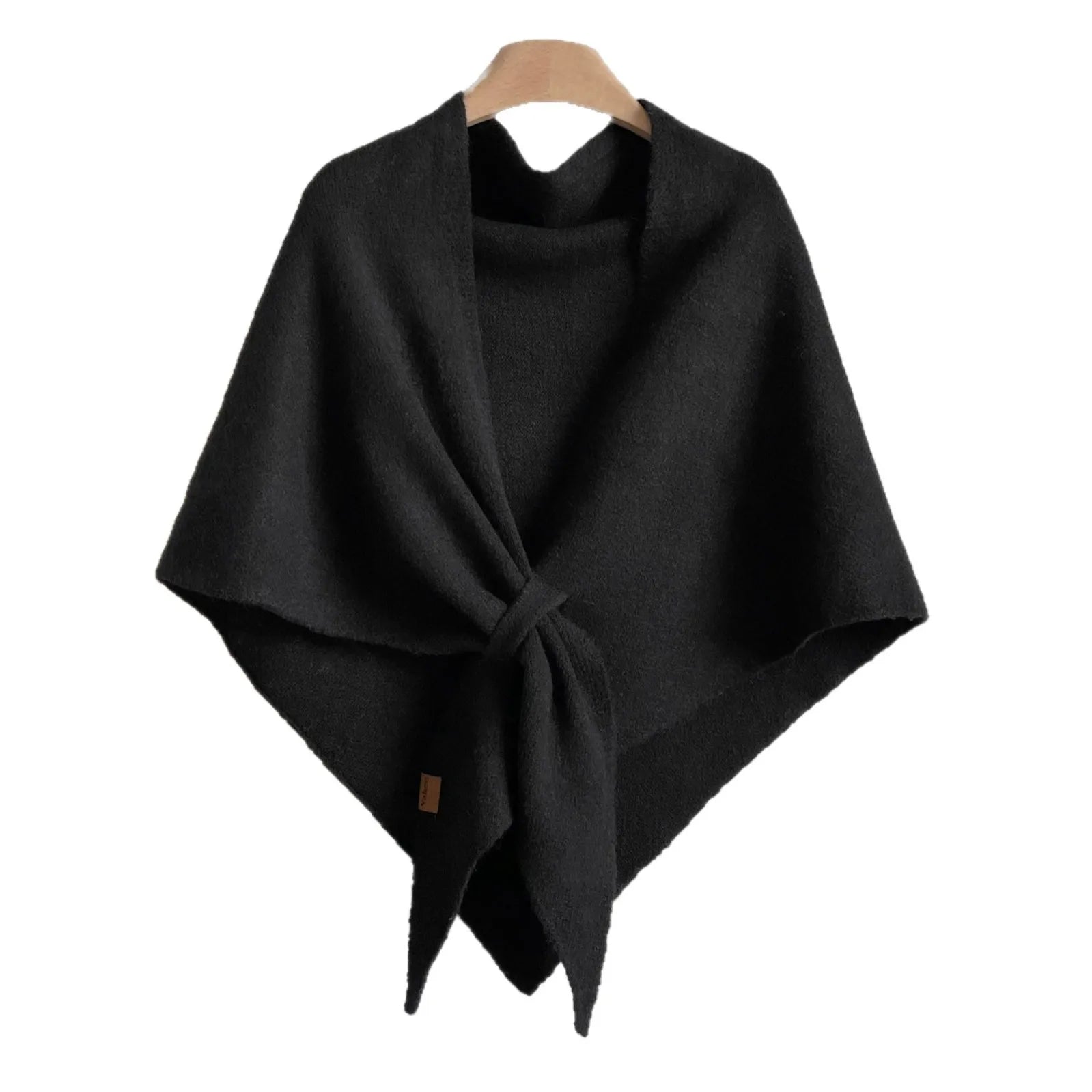 Black poncho on a wooden hanger against a white background