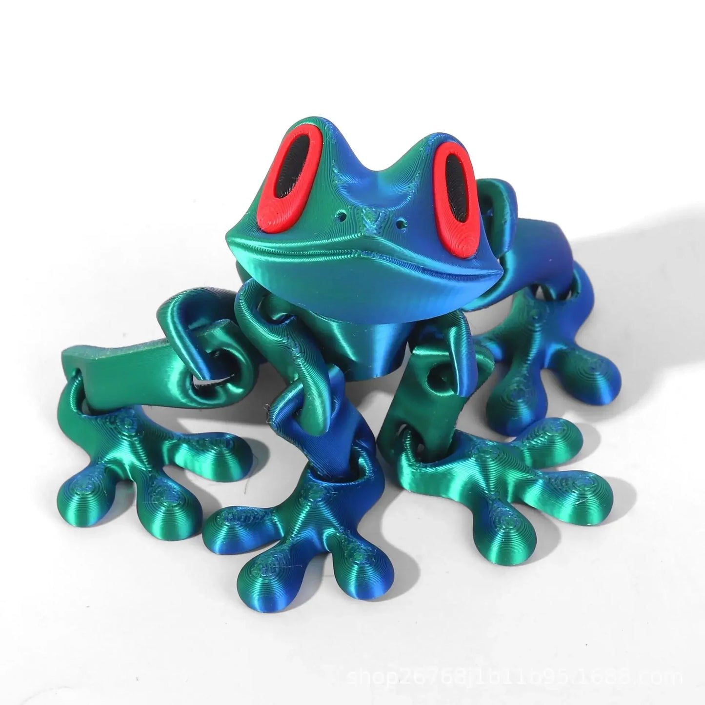 Metallic blue and green frog sculpture on a white background