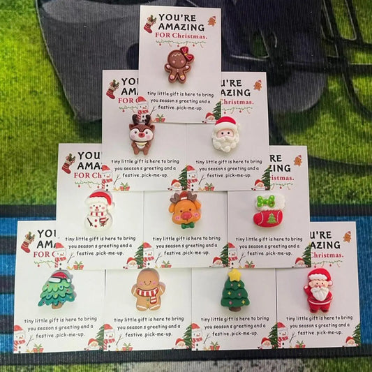 Set of Christmas-themed cards with small figurines on a green surface