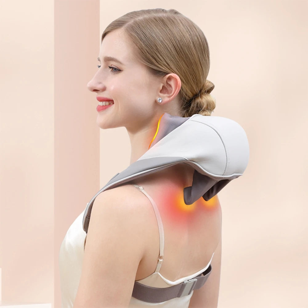 Woman using a neck and shoulder massager on a plain background