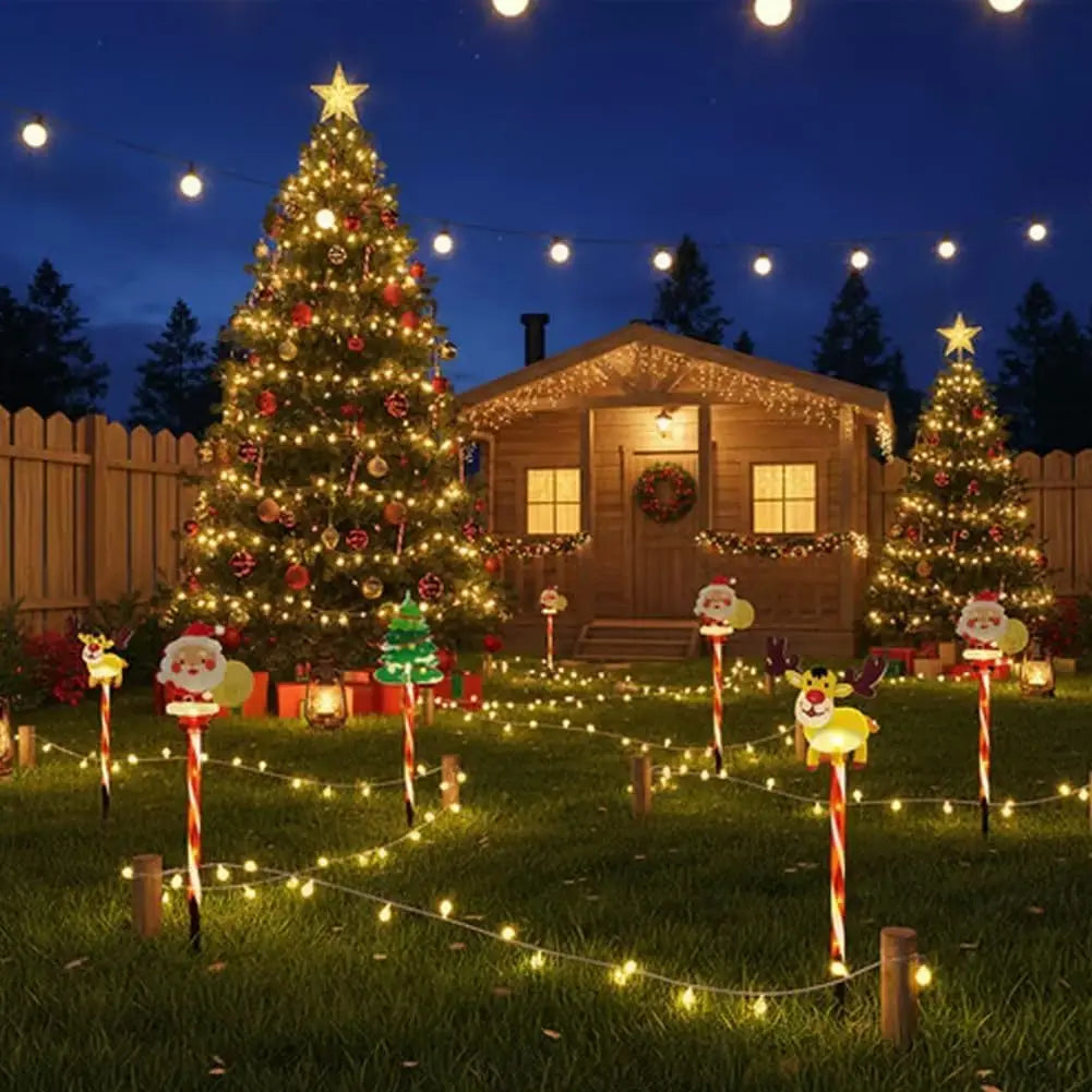 Decorative Christmas scene with two large trees, lights, and festive decorations in a backyard setting.