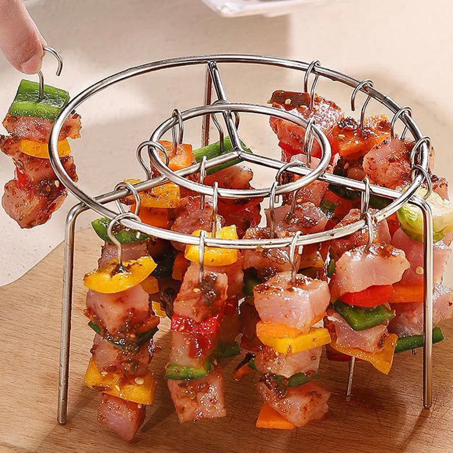 Metal skewer holder with skewers of meat and vegetables on a wooden surface