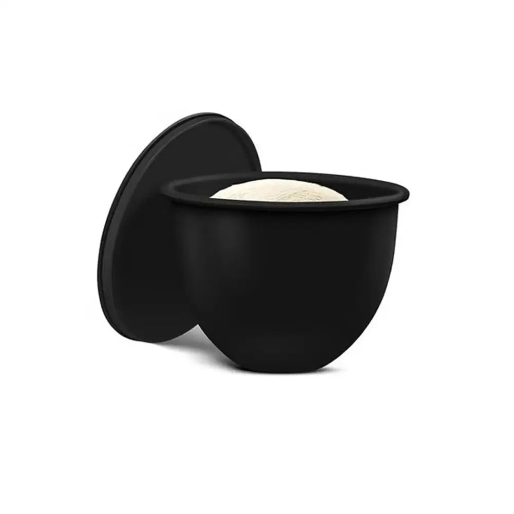 Black silicone lid on a black bowl with a white interior against a white background