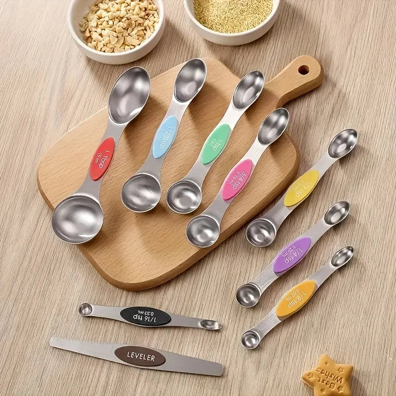 Set of measuring spoons with color-coded handles on a wooden board.