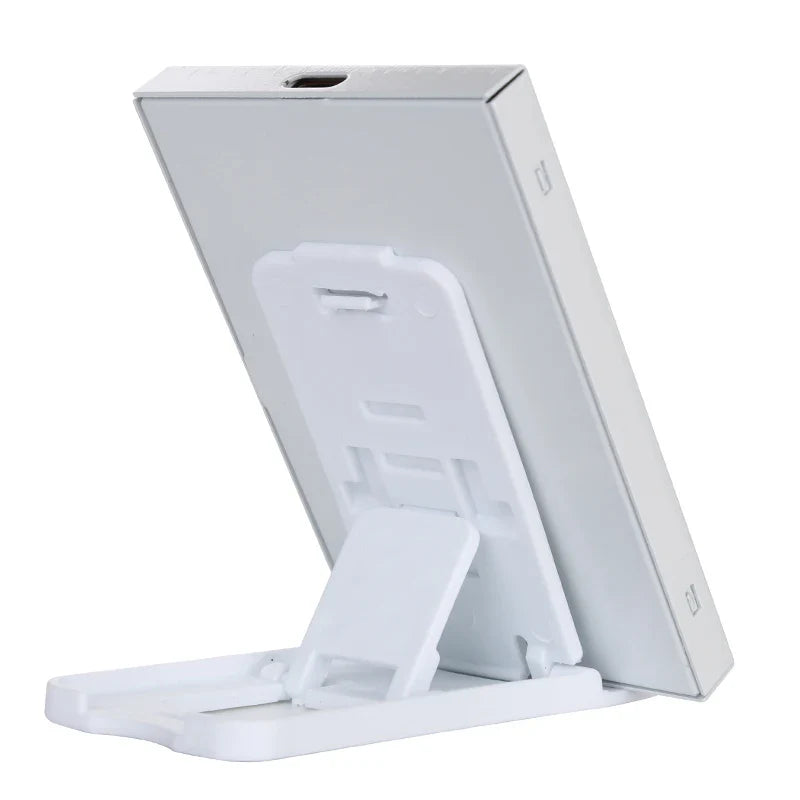 White phone stand with a phone on top on a white background