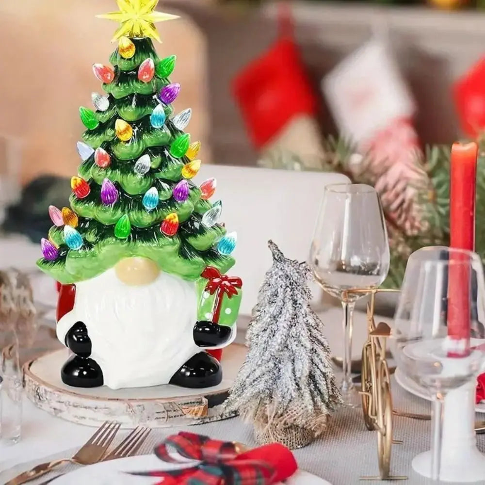 Decorative Christmas tree with colorful lights on a table setting with wine glasses and candles.
