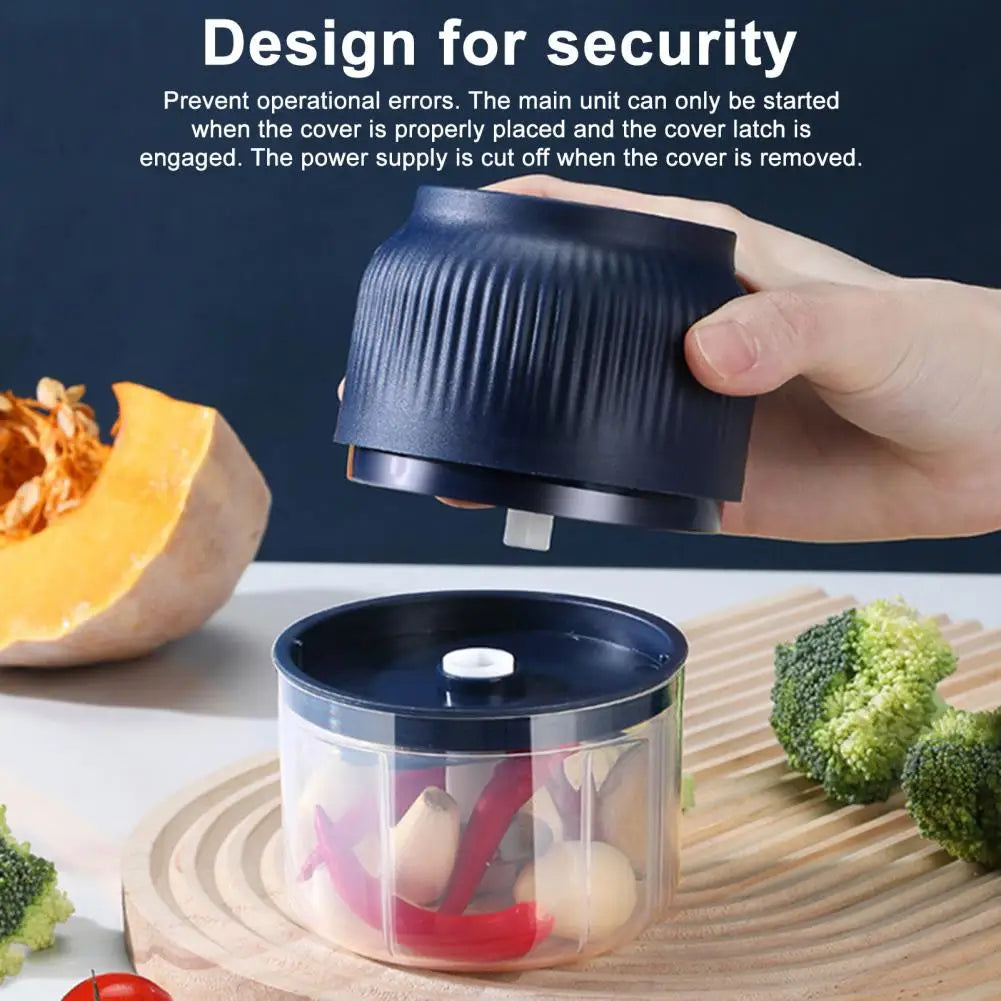 Hand holding a blue food chopper with text about security features on a kitchen counter.