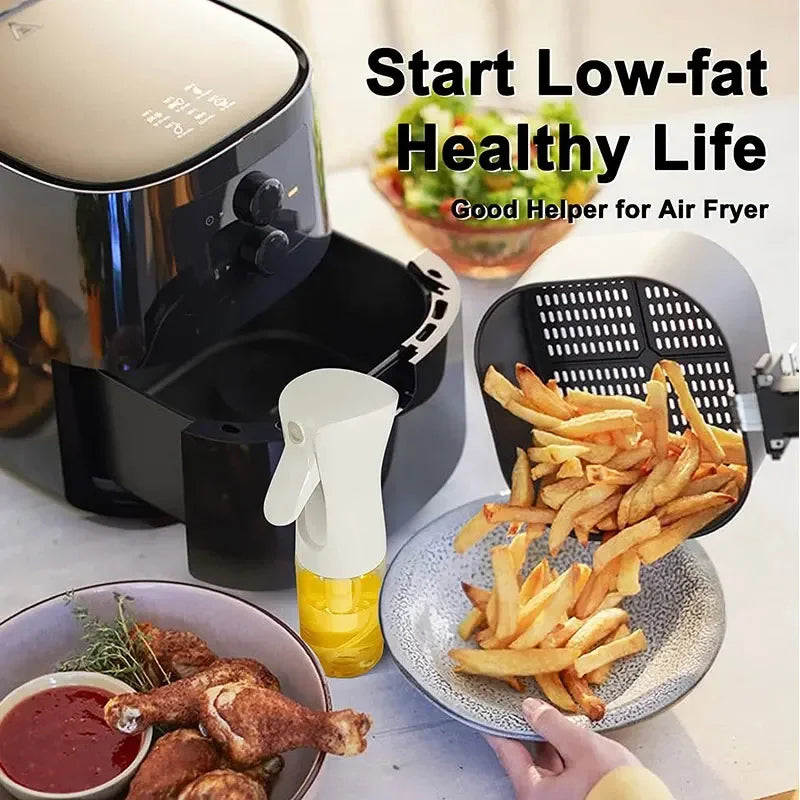 Air fryer with cooked french fries on a plate, surrounded by food items and a bottle of oil.