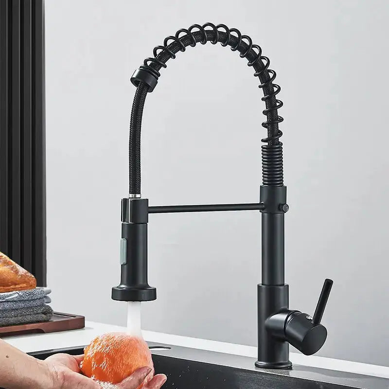 Black kitchen faucet with a flexible hose in a kitchen setting.