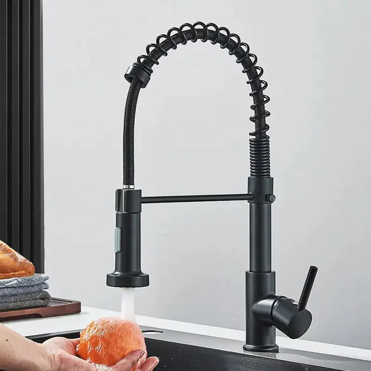Black kitchen faucet with a flexible hose in a kitchen setting.