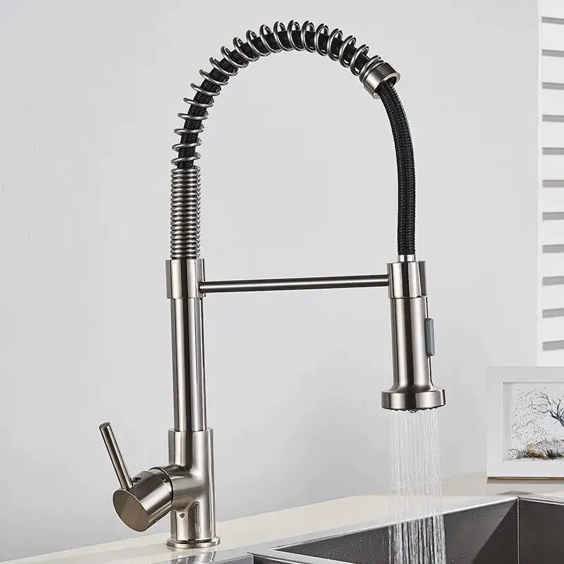 Stainless steel kitchen faucet with flexible hose on a white background