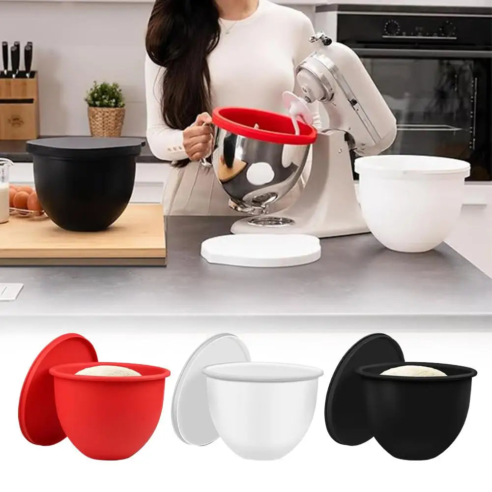 Silicone mixing bowls in red, white, and black on a kitchen counter with a stand mixer.